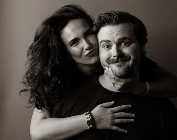 Black-and-white portrait of Chandler and Hannah Nigh, founders of Rare Breed Co., in a playful pose that reflects their creative partnership and agency culture.