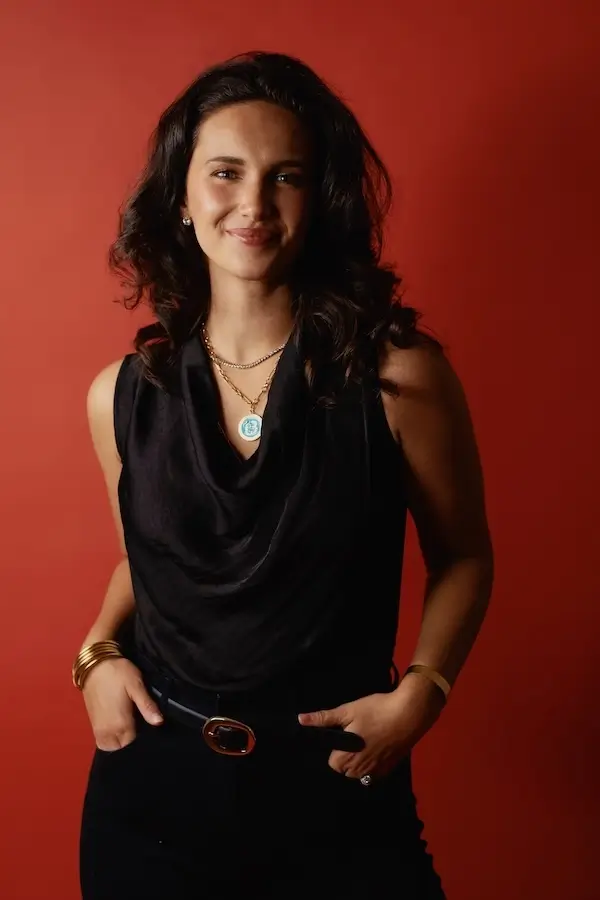 Portrait photo of Rare Breed Co. co-founder and Chief Creative Officer, Hannah Nigh, featuring a red background.